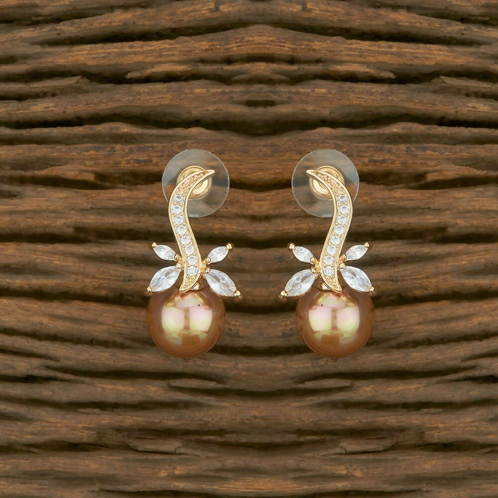 A pair of elegant golden brass earrings with white AD stones for women.