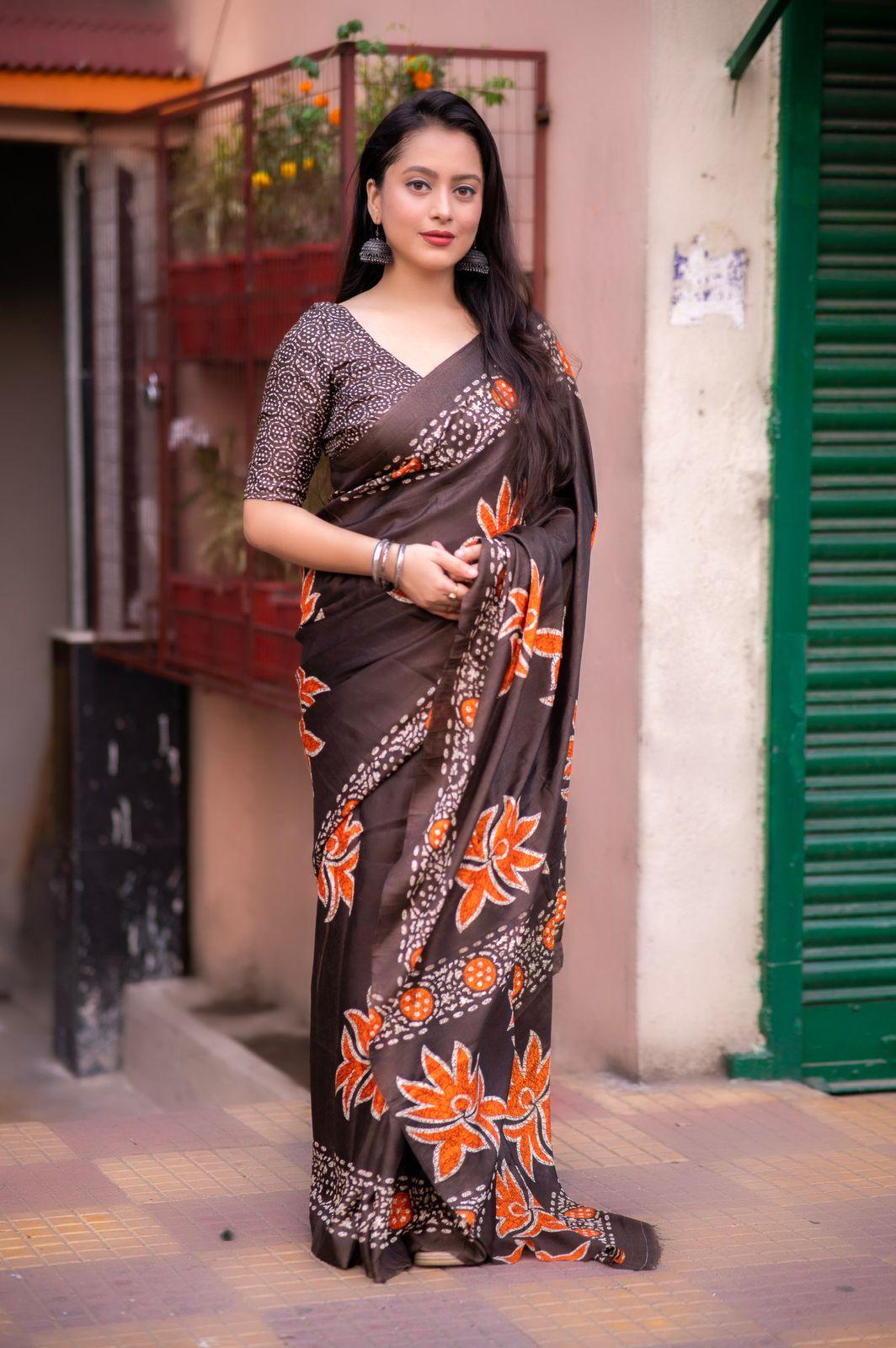 Coffee brown and orange silk blend saree with ethnic batik-style motifs and matching dolla silk blouse