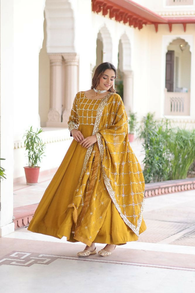 Yellow silk kurta set with intricate sequins, zari, and thread embroidery detail