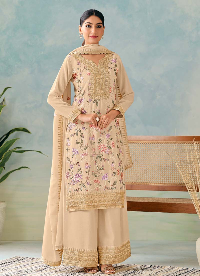 Woman wearing a cream premium Chinon embroidered palazzo suit with intricate embroidery details.