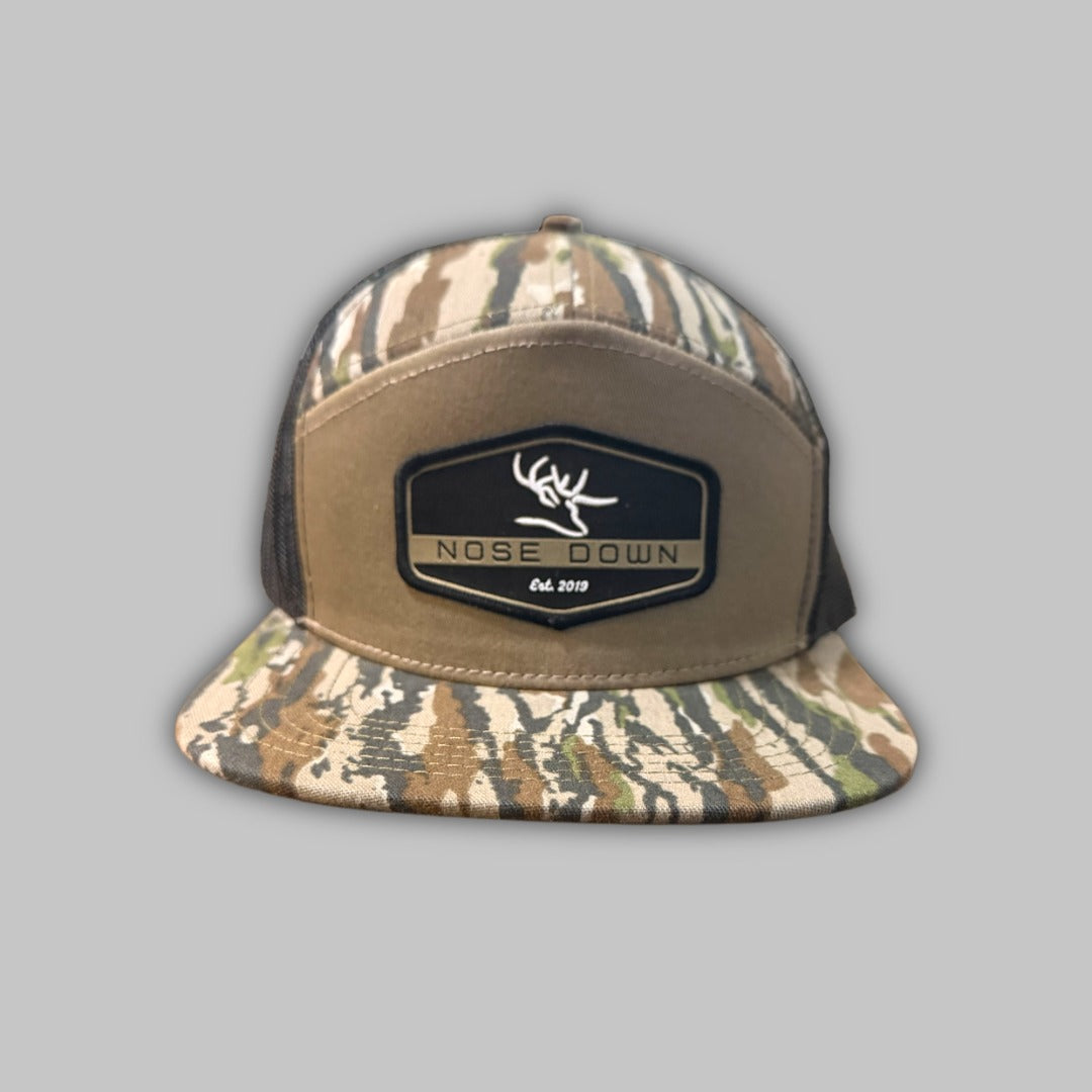 Black 7 panel hat featuring a detailed black hex woven patch on the front.
