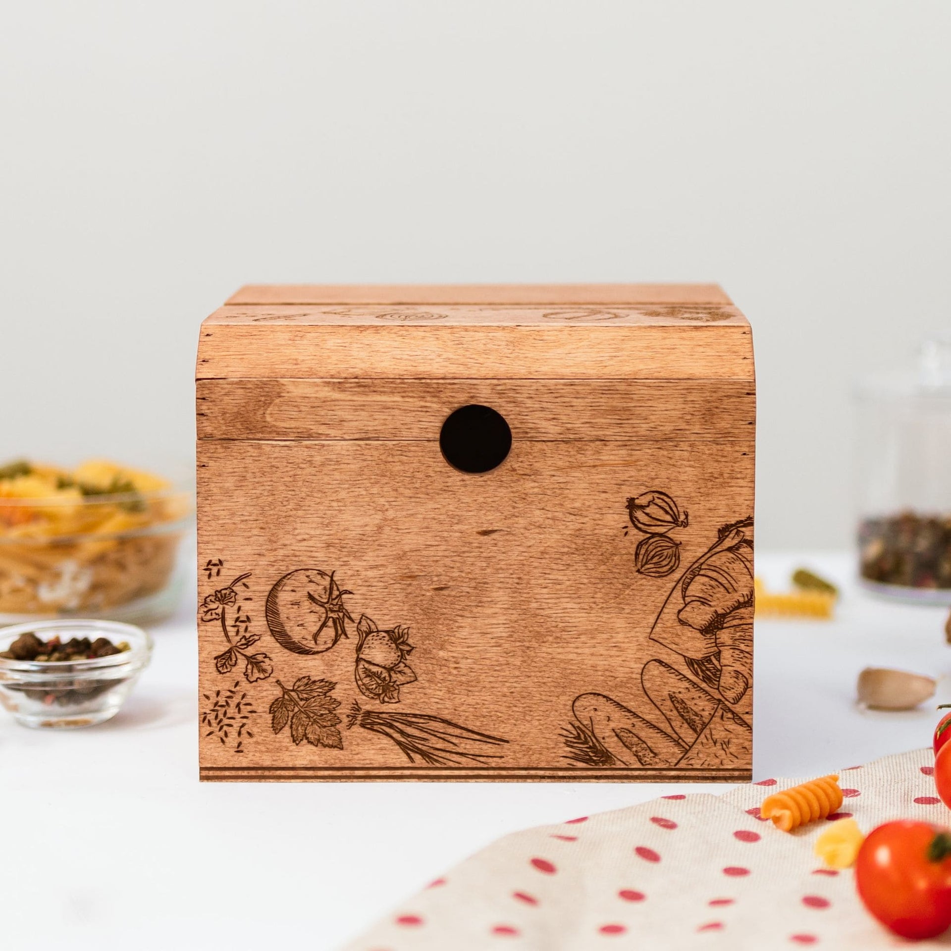 Wooden recipe box with peppers theme illustration on the lid sitting on a kitchen counter.
