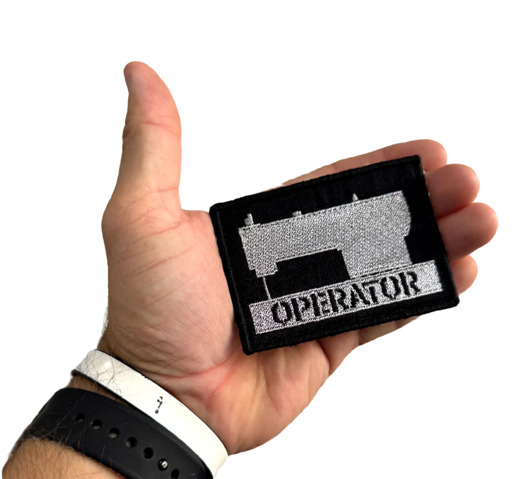 Close up of Recycled Firefighter Operator Patch in black and silver with sewing machine motif