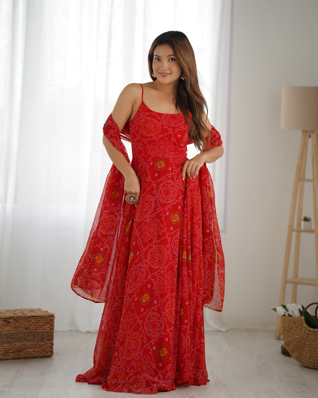 Red chiffon Bandhej print Anarkali gown with full flare, backless dori detail, pants, and dupatta.