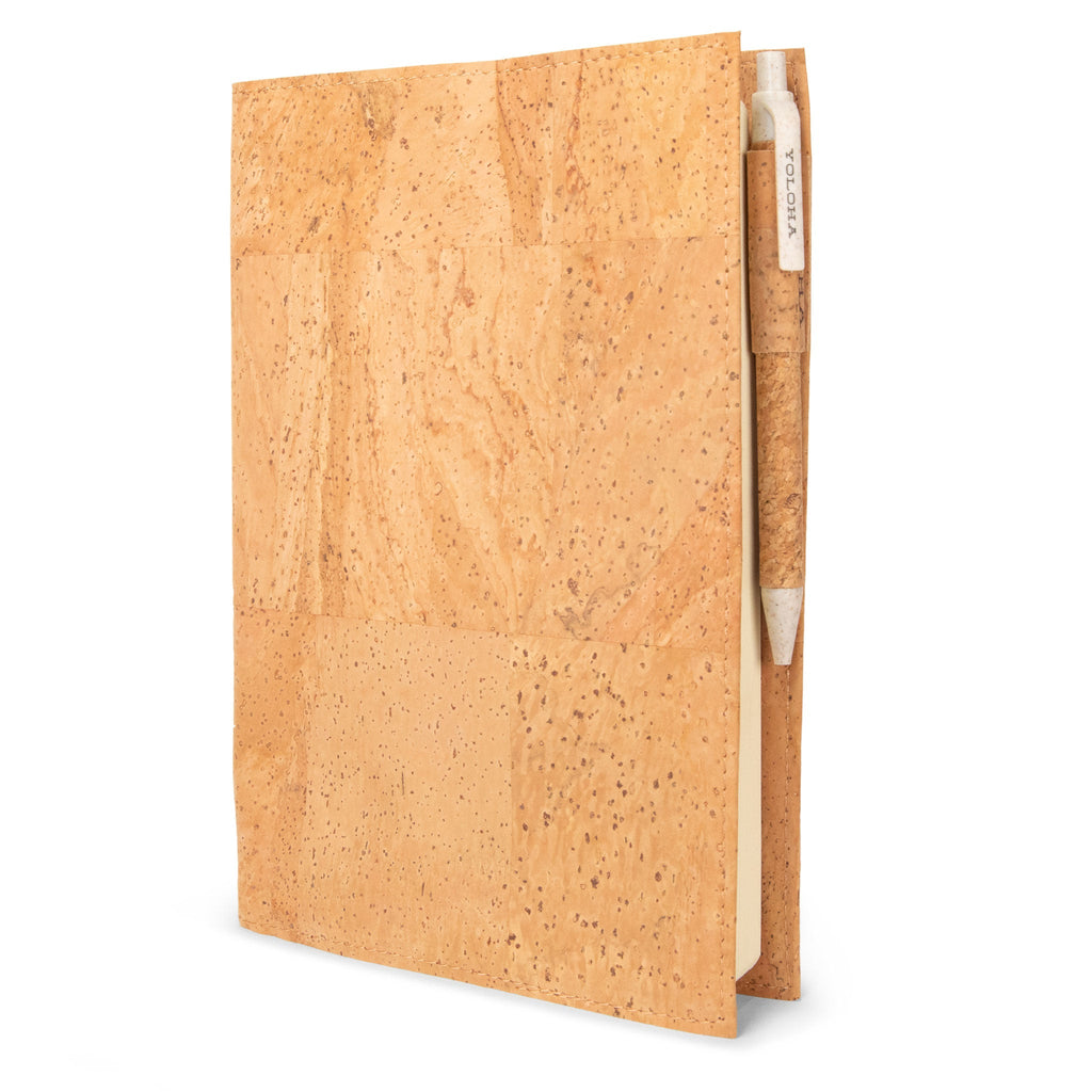 Minimalist tan cork A5 refillable journal with cork-grip pen on an office desk