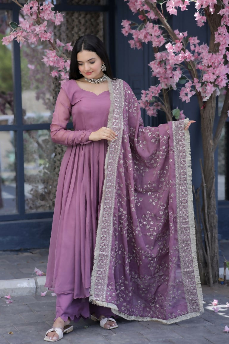 Model wearing an elegant onion pink tabby silk A-line kurta with matching plazo and dupatta