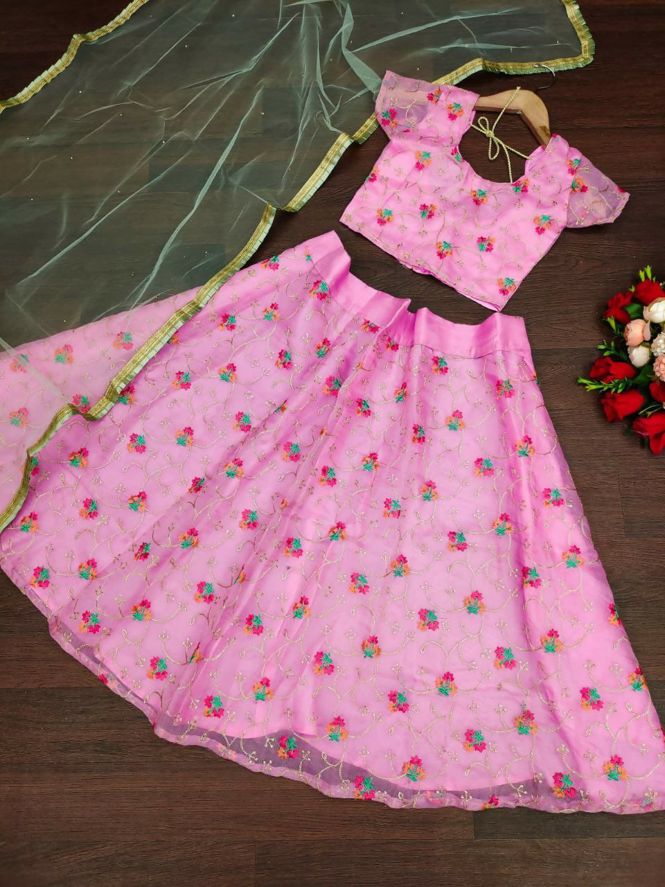 Beautiful pink organza silk kids lehenga choli with detailed embroidery.