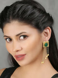 Long matte gold earrings featuring green stones and golden bead detailing.