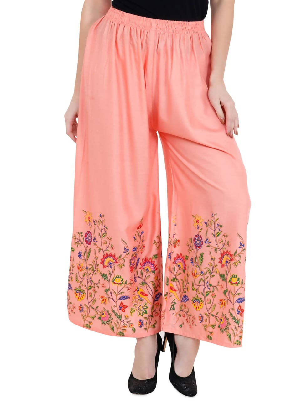 Peach palazzo pants with a beautiful floral print and a wide-leg cut.