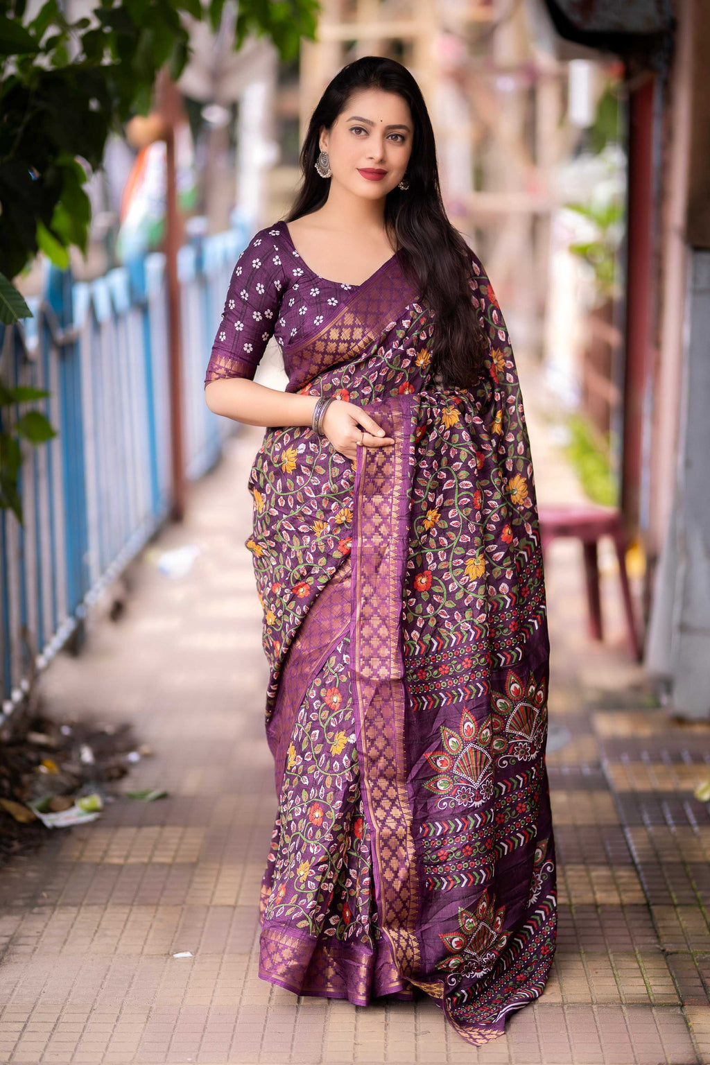 Purple slub silk saree with printed patterns and gold jacquard zari border.