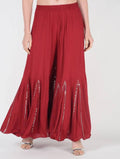 Maroon flared viscose rayon palazzos featuring intricate mirror lace work detailing.