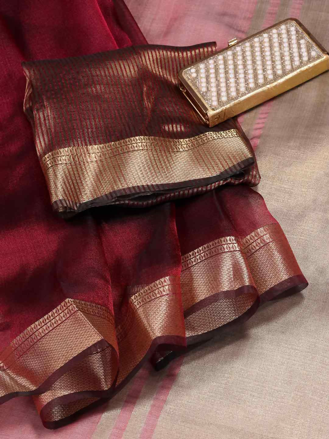 Maroon organza saree with a sheer finish, perfect for evening occasions.