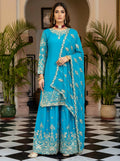 A front view of a sky blue silk embroidered kurti paired with a matching sharara set.