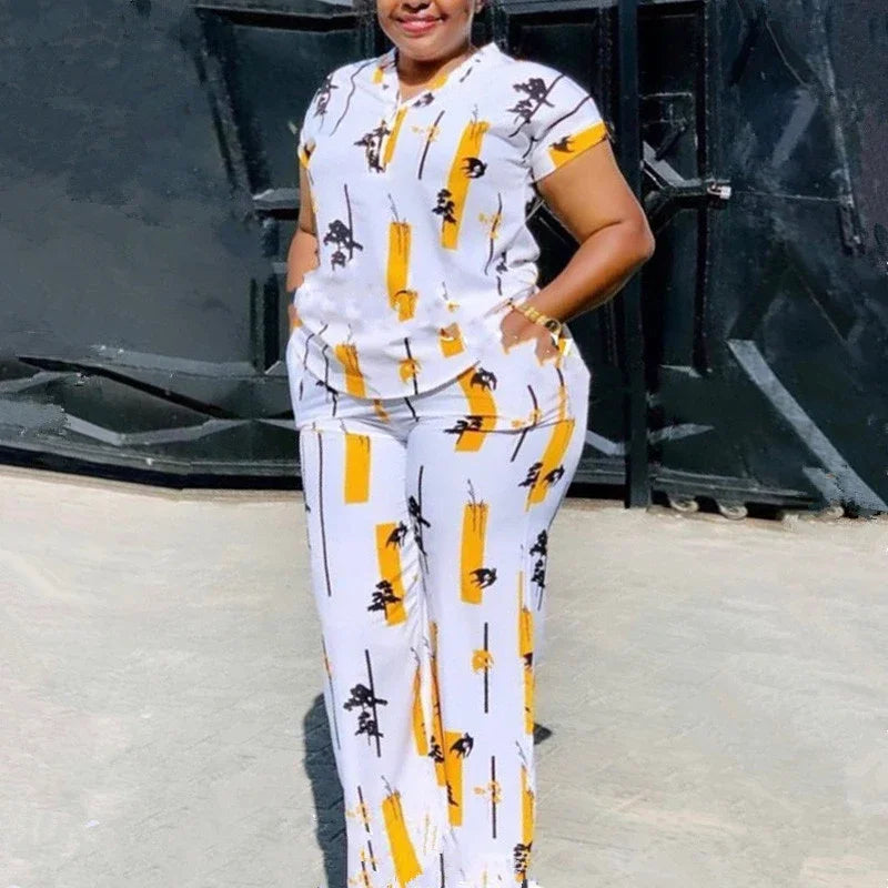 Woman wearing a matching two-piece set with a printed short sleeve blouse and straight leg trousers.