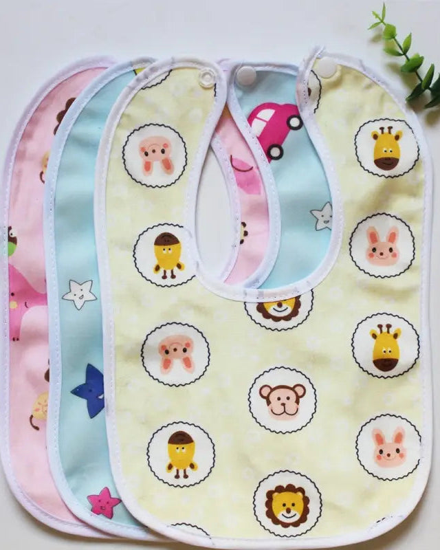 Three baby bibs with animal patterns on a light background