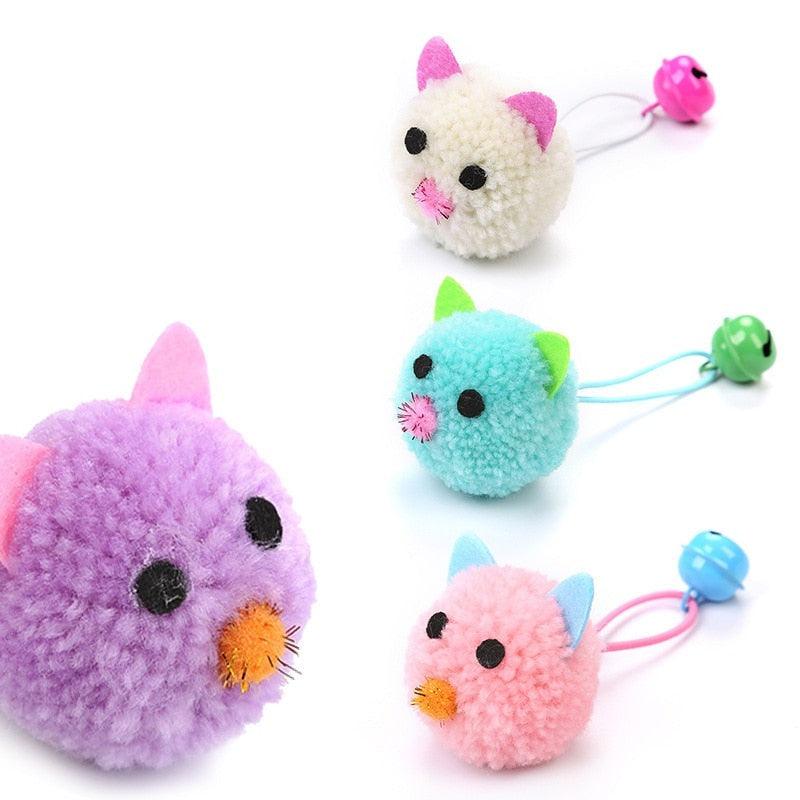 A set of four colorful plush mouse cat toys in purple, pink, light-blue, and cream with attached bells.