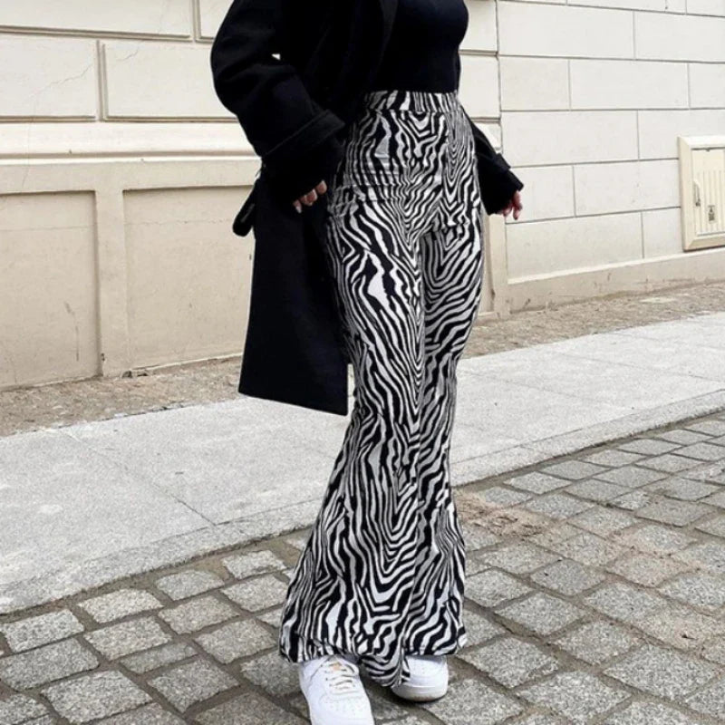 Woman wearing zebra print high waist wide leg pants with white sneakers