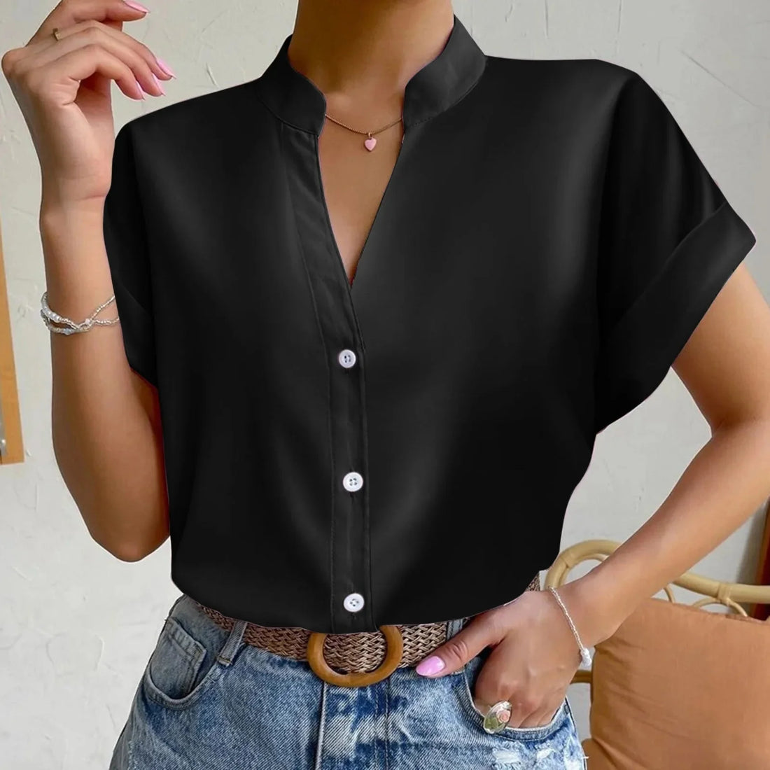 Model wearing a stylish satin V-neck short sleeve button-down blouse in pink and black color options