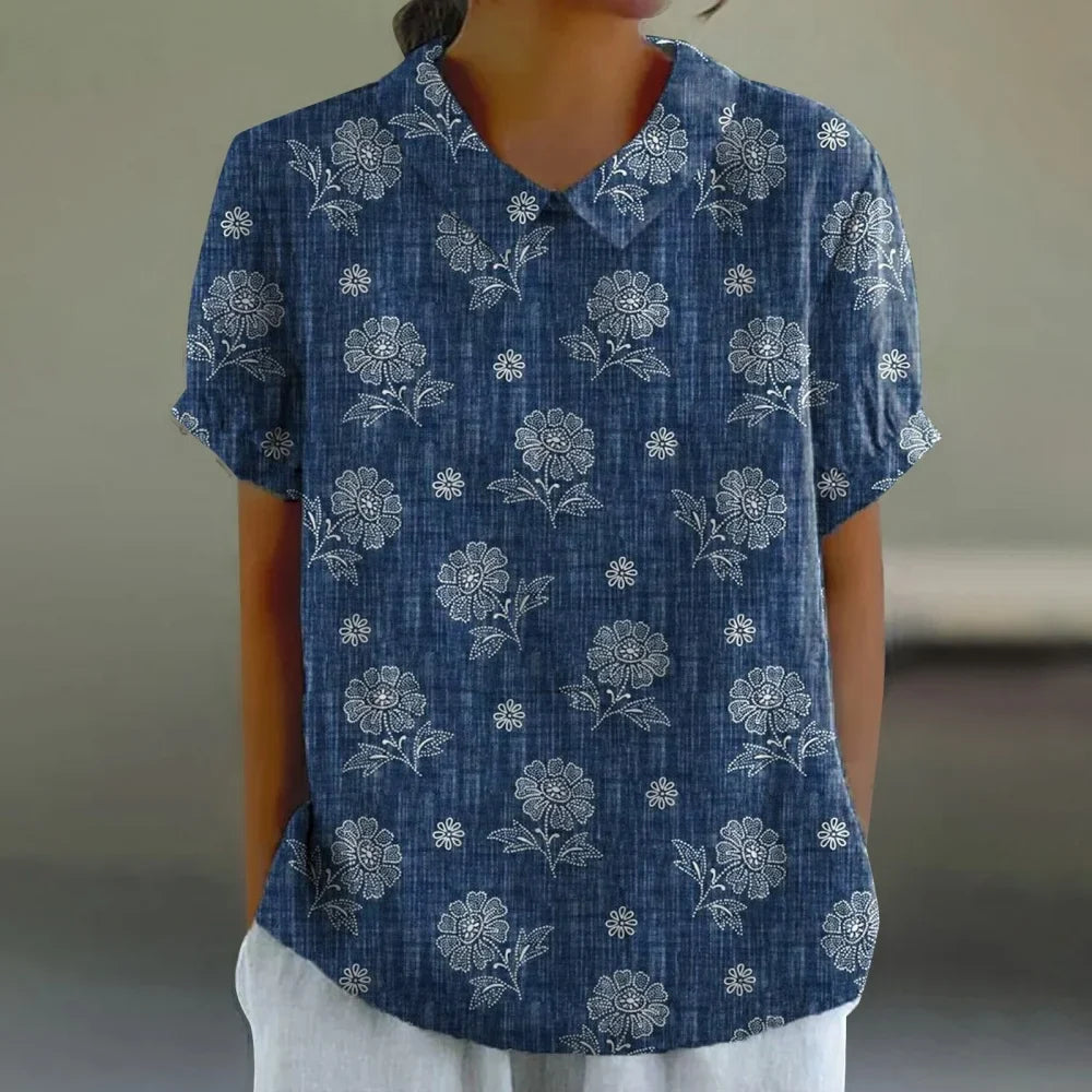 Woman wearing a floral print blouse with puff sleeves and a Peter Pan collar