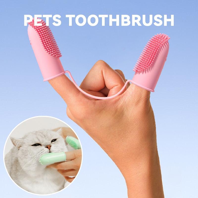 Pastel pink and mint green dual-finger silicone pet toothbrush for dog and cat dental care.