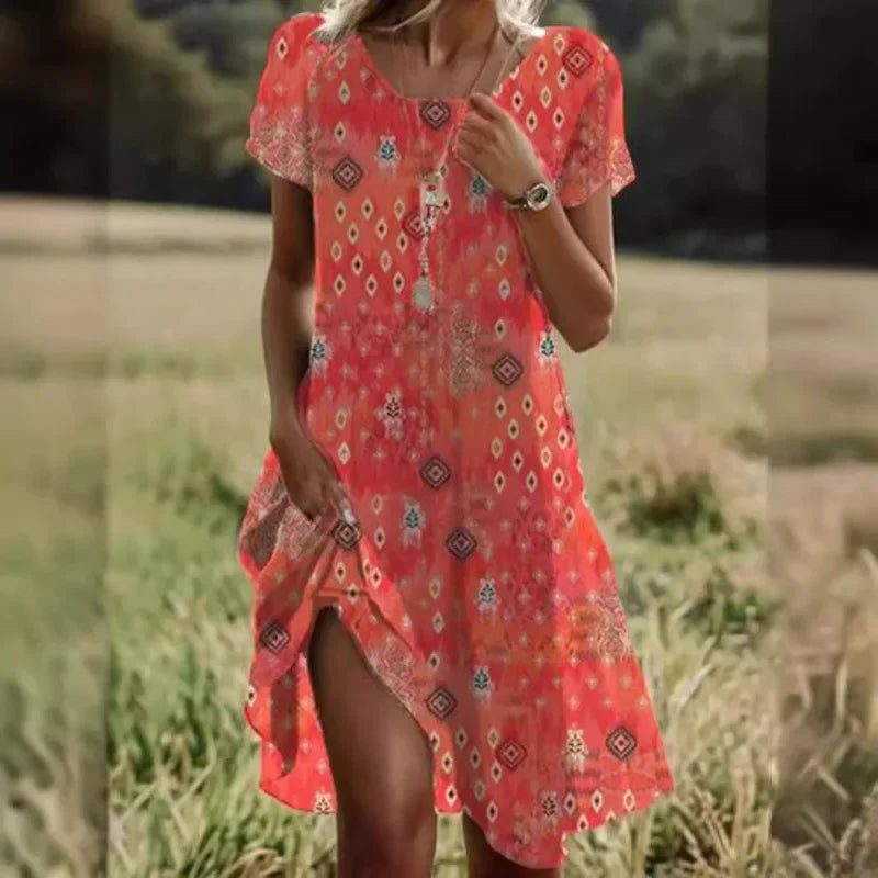 A woman wearing a vibrant ethnic print short-sleeve midi dress with a round neck in a natural field setting.