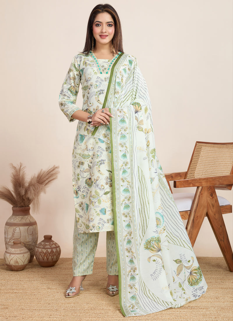 Model wearing an off white printed cotton blend salwar suit with matching pants and dupatta.