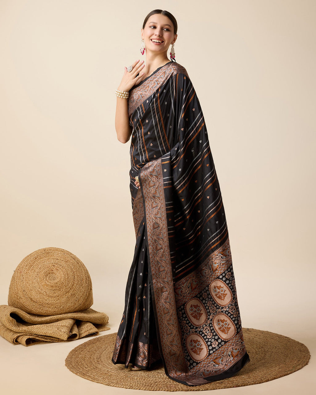 Black Pure Jacquard party saree with ornate gold and silver Jari work.