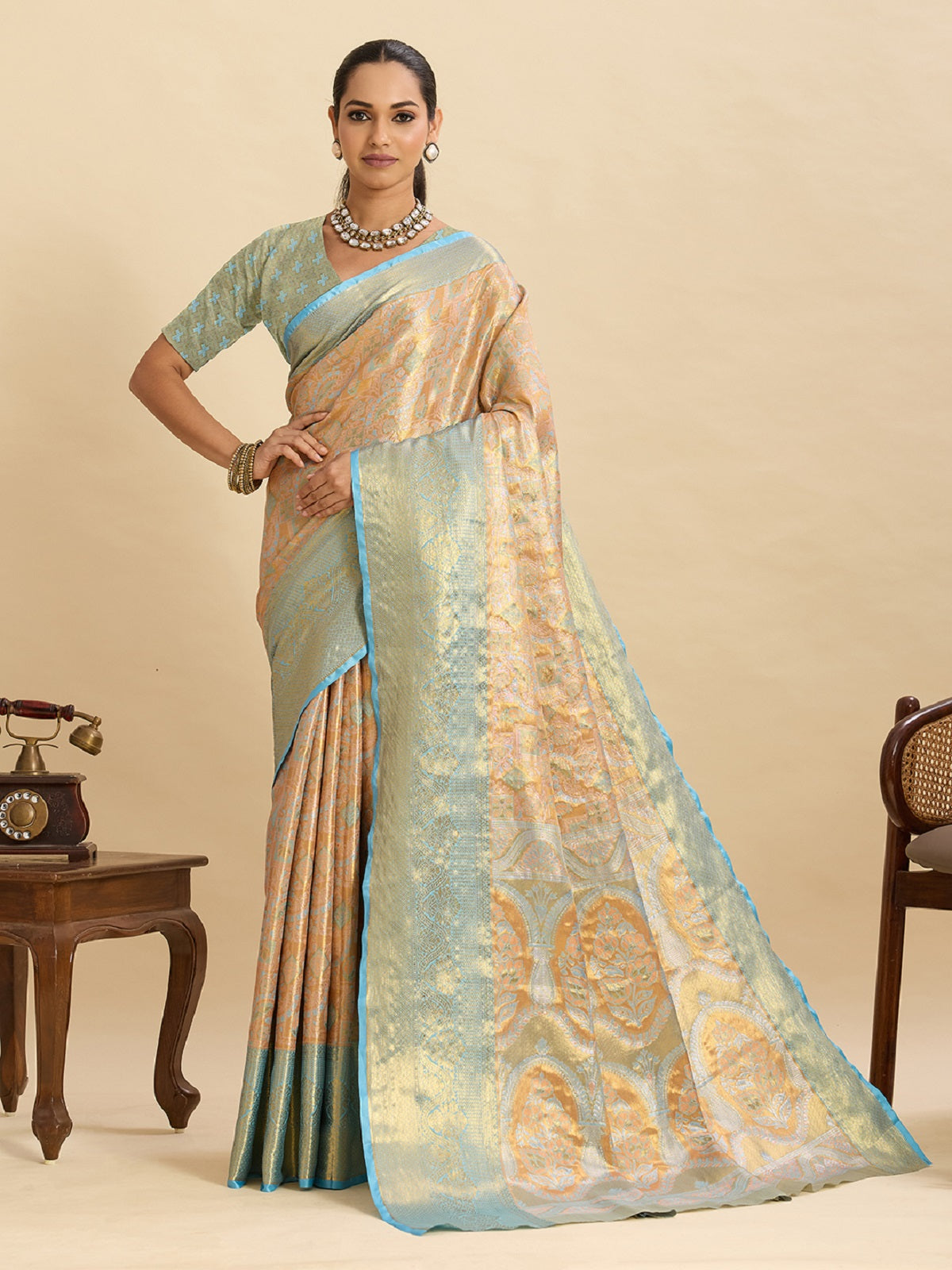 Beige Kanjivaram Silk wedding saree with traditional gold Jari weaving.