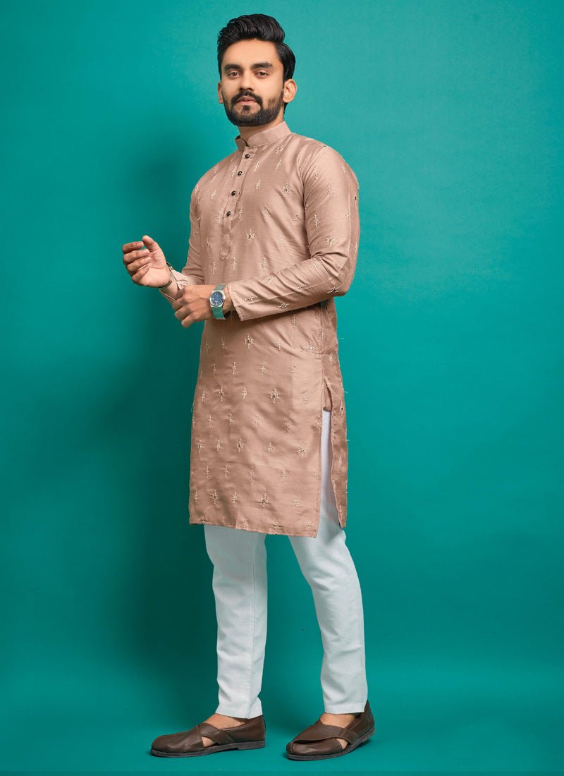Close-up of a light peach silk kurta with intricate embroidery for baby boys