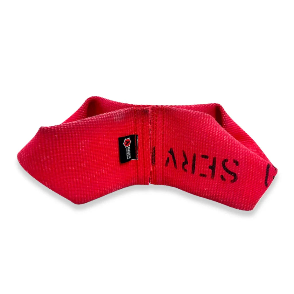 A durable, red and yellow double-loop firehose tug toy for dogs on an outdoor surface