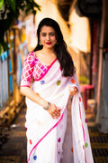 White pure linen polka dot saree with zari pattu border, cotton tassels, and rani printed blouse.