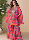 Woman wearing a vibrant multicolor abstract floral print silk sharara suit with V-neckline