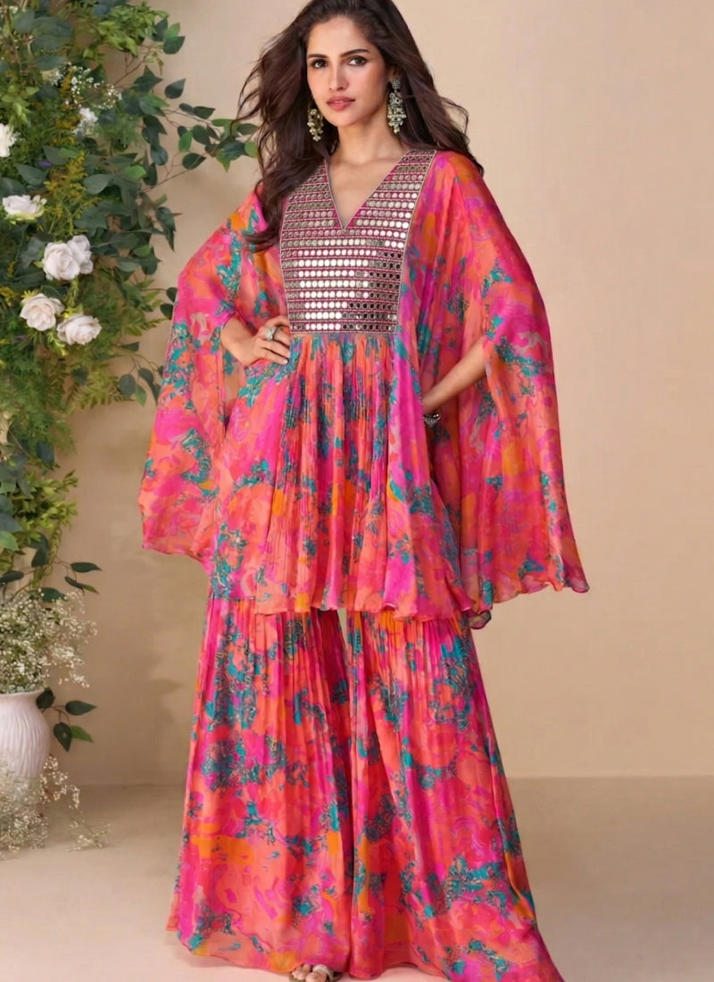 Woman wearing a vibrant multicolor abstract floral print silk sharara suit with V-neckline