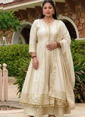 Woman wearing a cream cotton palazzo suit with gold gota accents and a relaxed A-line silhouette