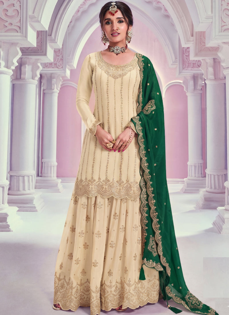 Elegant cream-colored Chinon silk palazzo suit featuring delicate Zari embroidery and a round neck kurta.