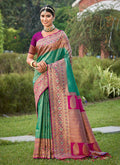Woman wearing a Rama Green Banarasi Silk Saree with gold border detail