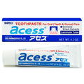 A tube of Sato Acess toothpaste for gum and teeth care, white, blue, and red packaging