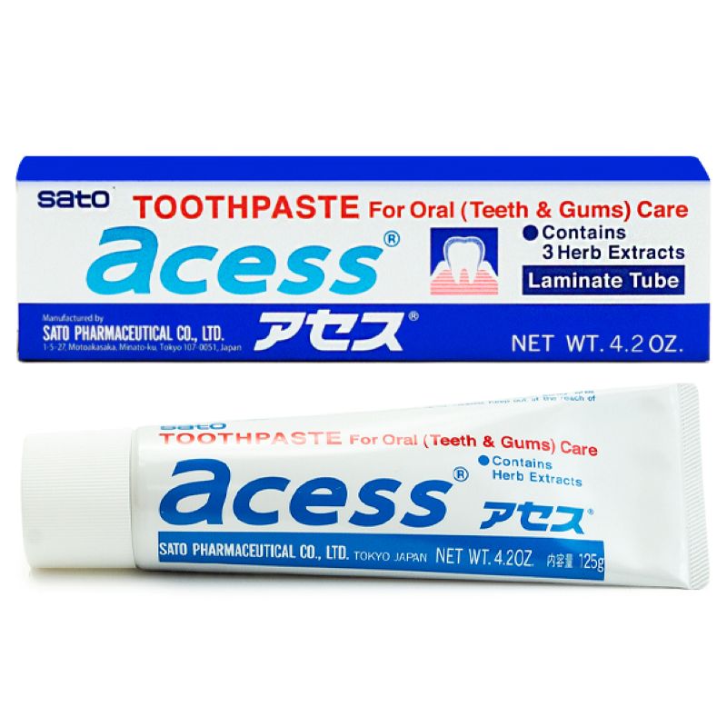 A tube of Sato Acess toothpaste for gum and teeth care, white, blue, and red packaging