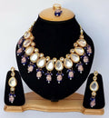 Close up of a blue Kundan stone-studded necklace set with gold plating and adjustable cord.