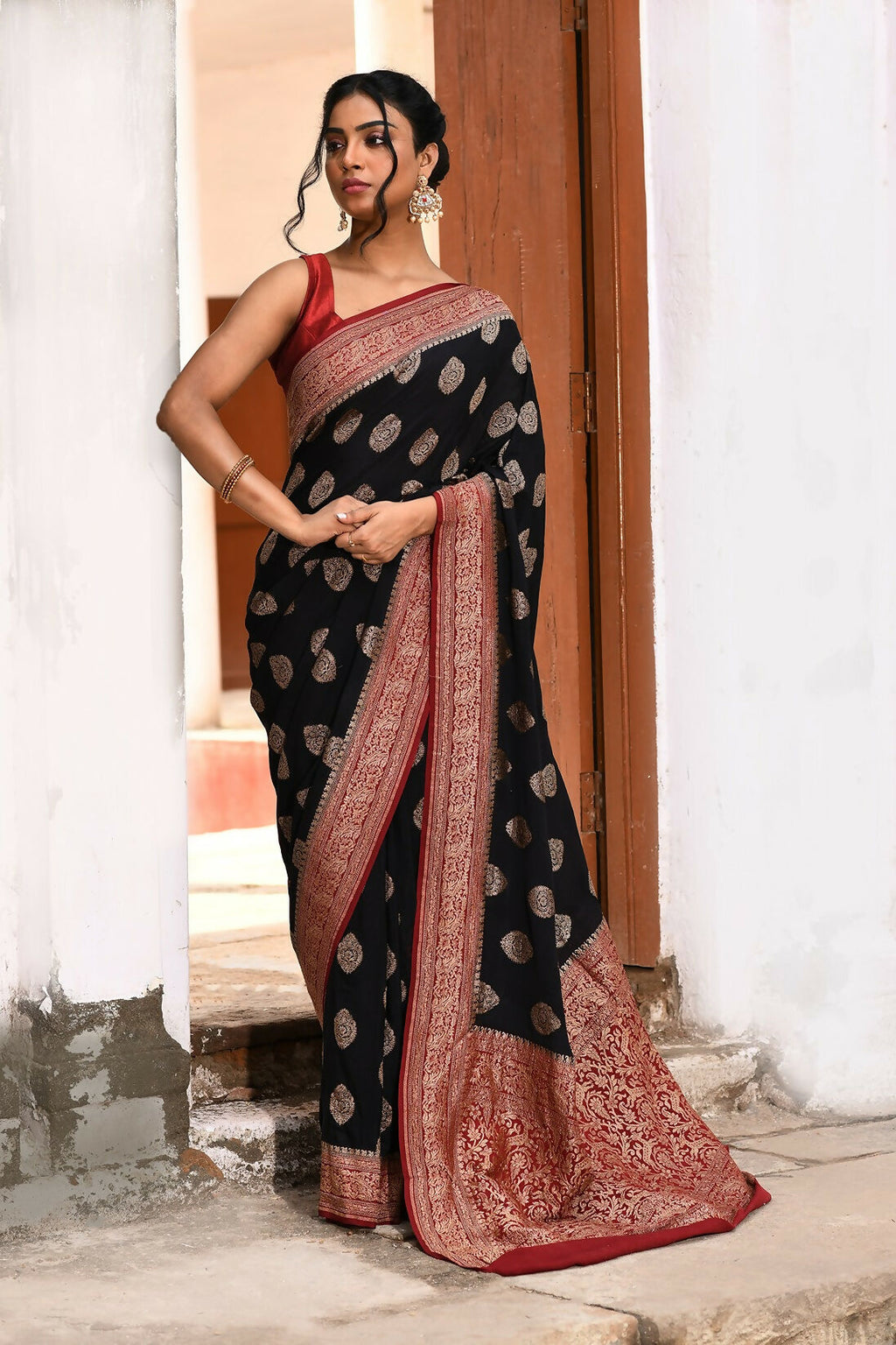Sophisticated black crepe chiffon Banarasi handloom saree with a fluid drape.