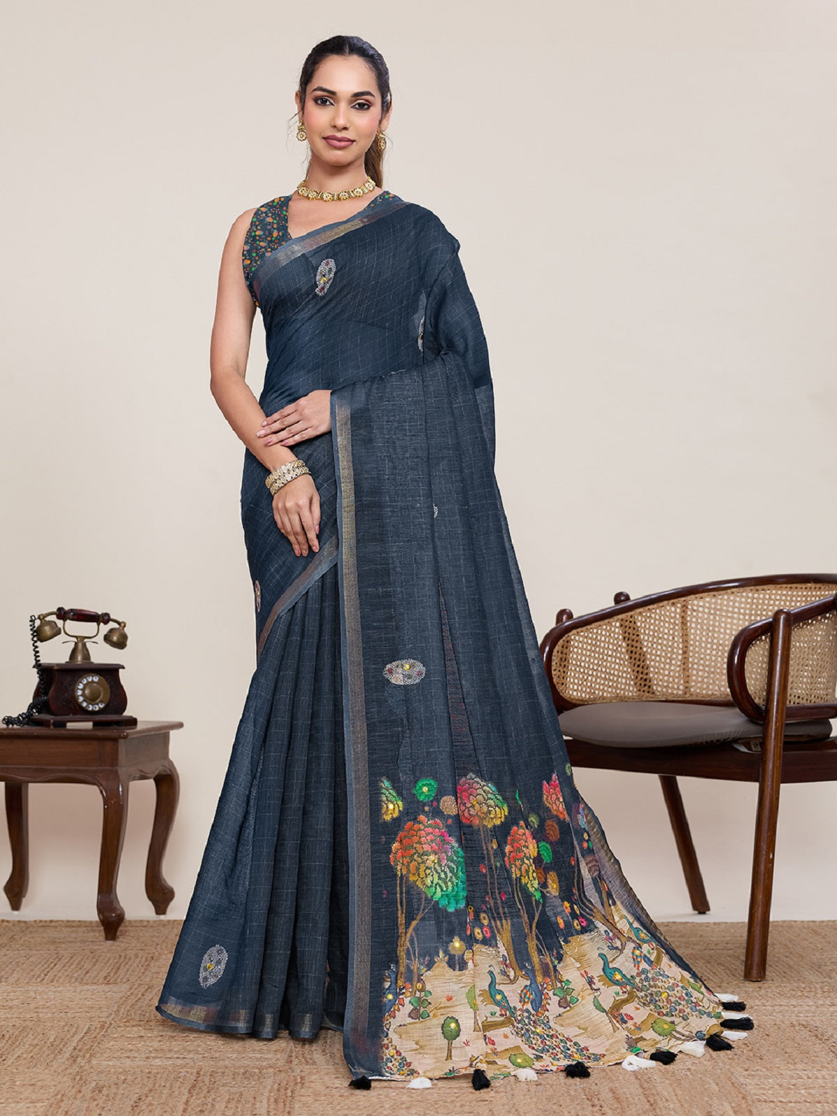 Black linen saree adorned with mirror work detail and matching unstitched blouse