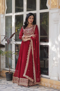 Woman wearing a long maroon Faux Blooming Anarkali set with gold sequins and zari embroidery.