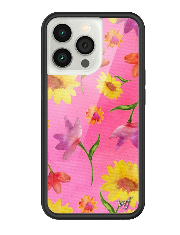 A phone case featuring a bright pink background with watercolor-style yellow sunflowers and purple tulips, enclosed in a black rubber protective bumper.