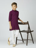 A young boy wearing a wine-colored cotton kurta and pyjama set featuring elegant sequin embroidery.