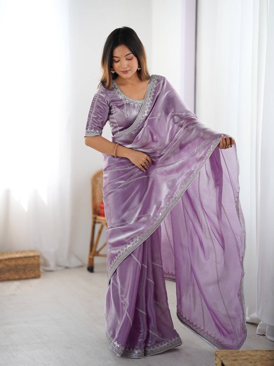 Lavender organza silk party wear saree with intricate thread and sequence embroidery.