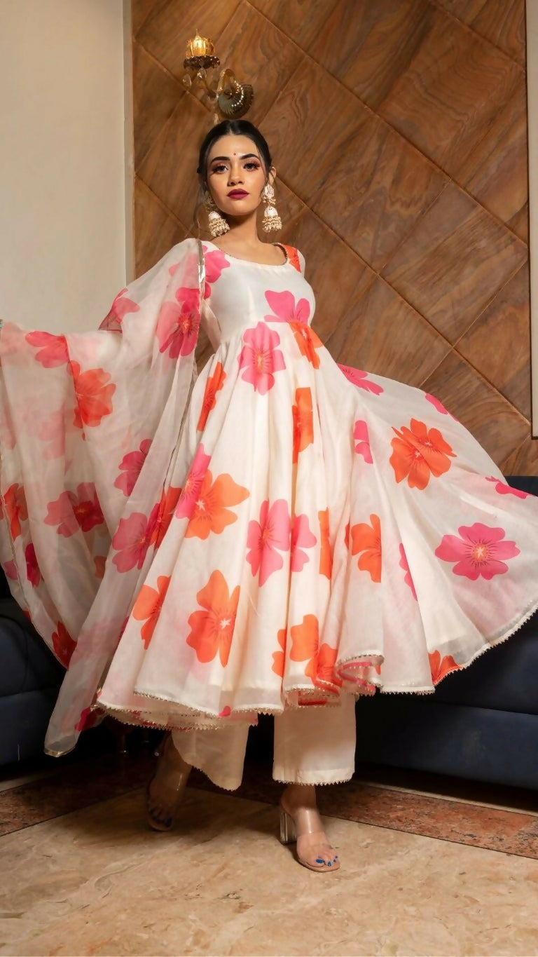 Woman wearing a Pink Heavy Chanderi floral digital printed A-line kurta with trousers and dupatta