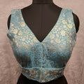 Blue Banarasi brocade readymade blouse with gold and silver woven detailing and V-neck.