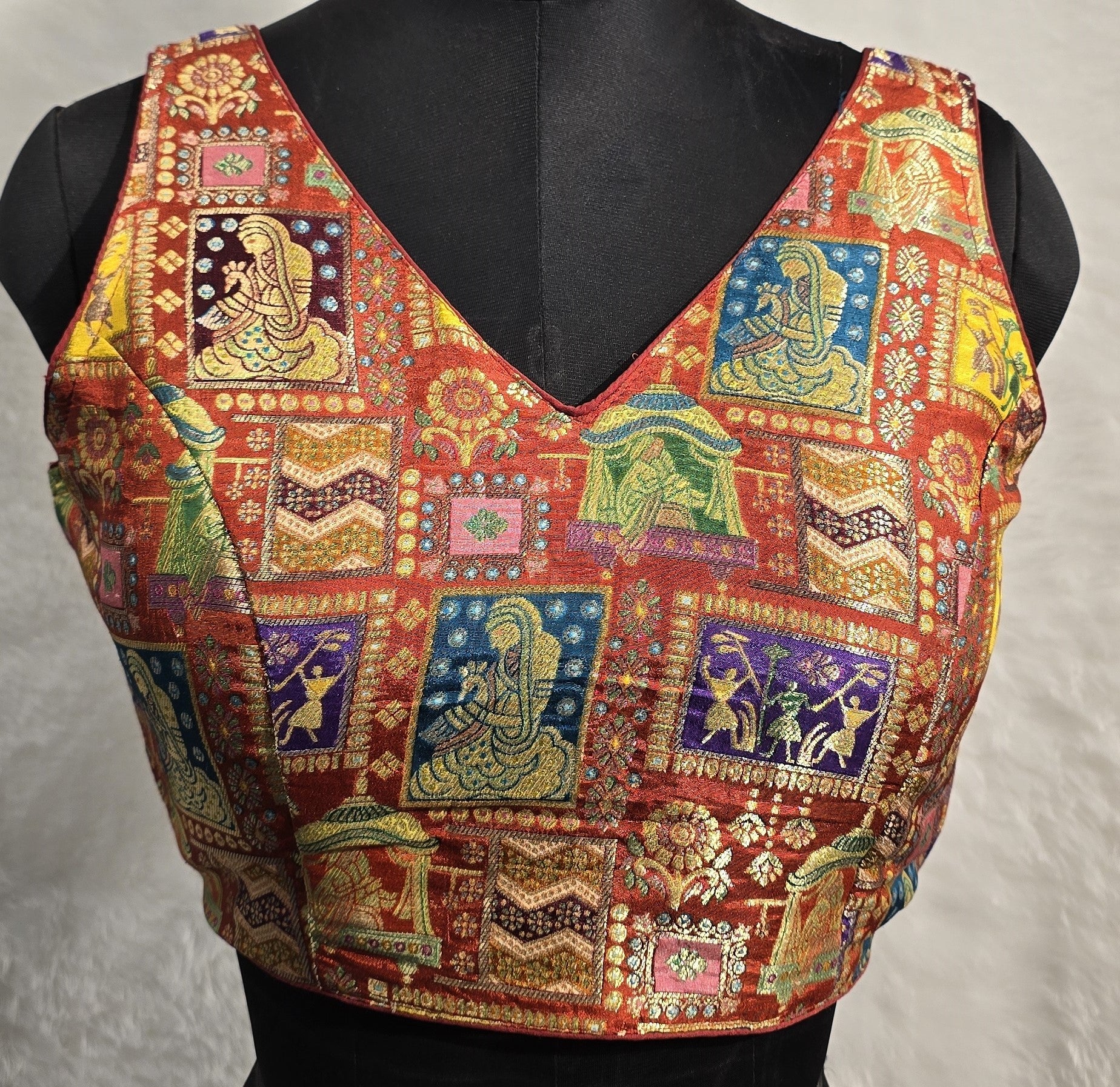 Rust colored Jacquard weave readymade blouse with V-neck and multi-color motifs