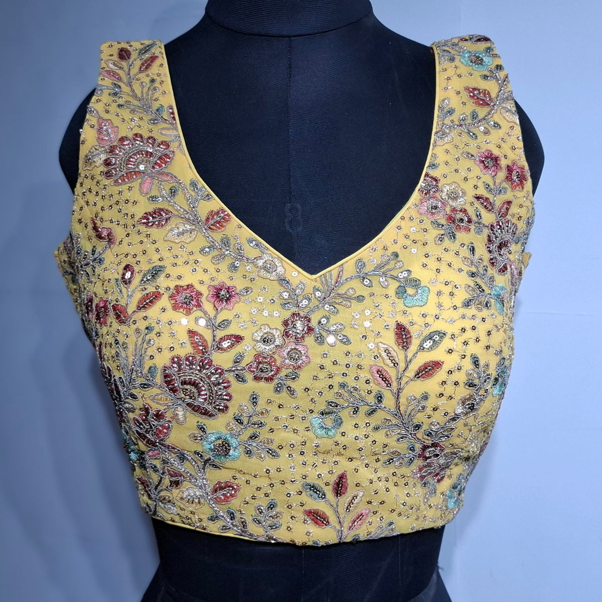 Eggyolk yellow georgette blouse with multi-color embroidery and sequin work