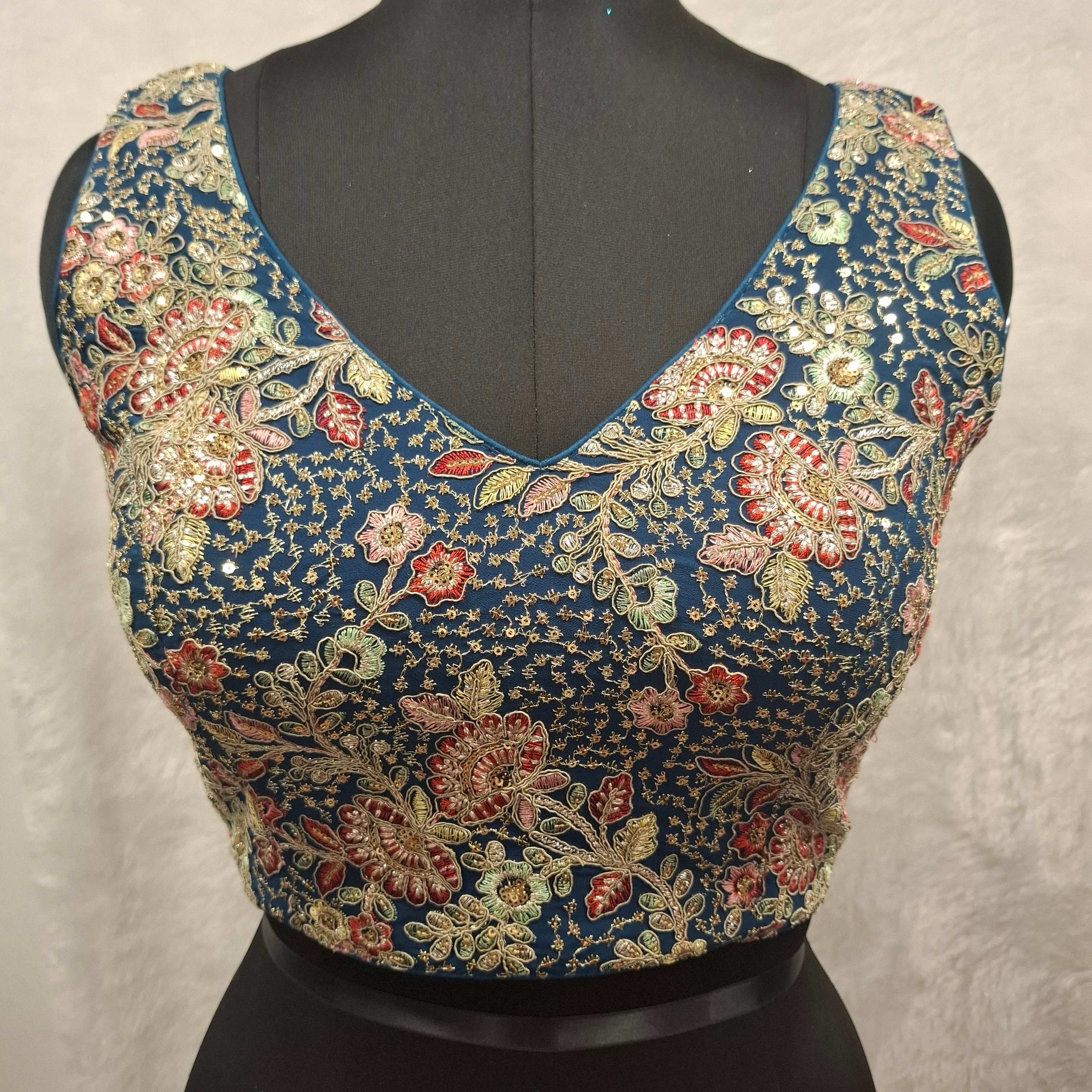 Teal Blue Georgette blouse with multicolor embroidery and princess cut design
